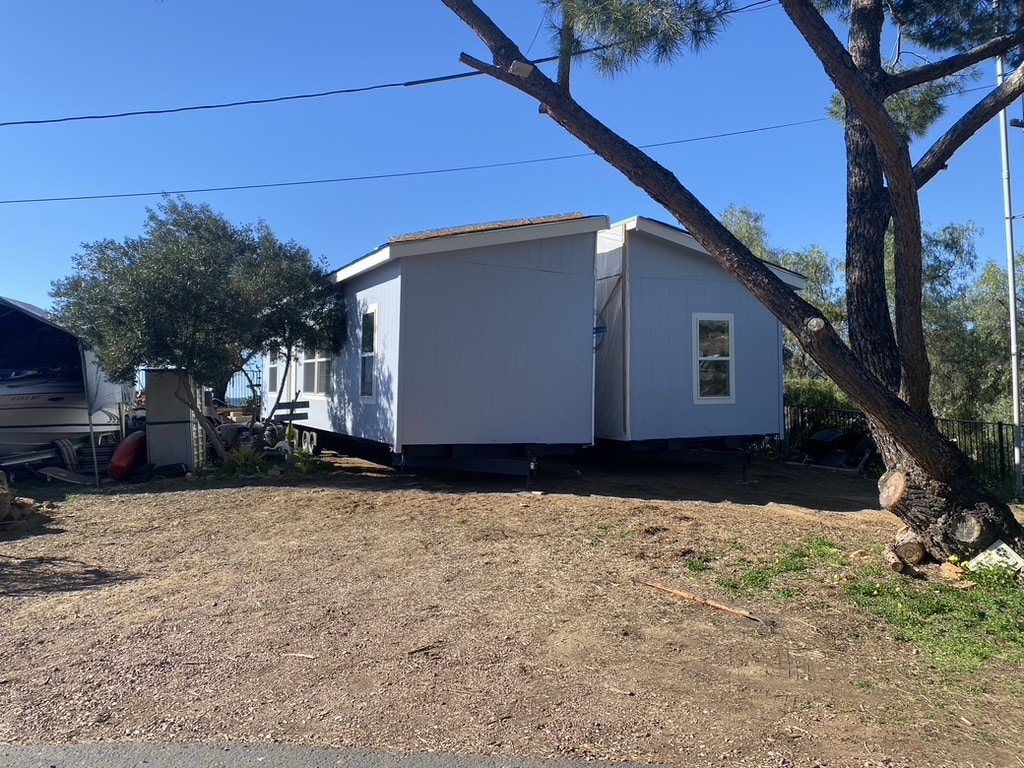 Manufactured home staged on cleared land before installation