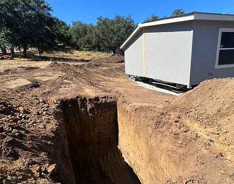 Utility trench prepared on site for manufactured home installation