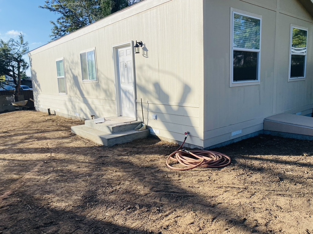 Manufactured home exterior with utility connections during installation