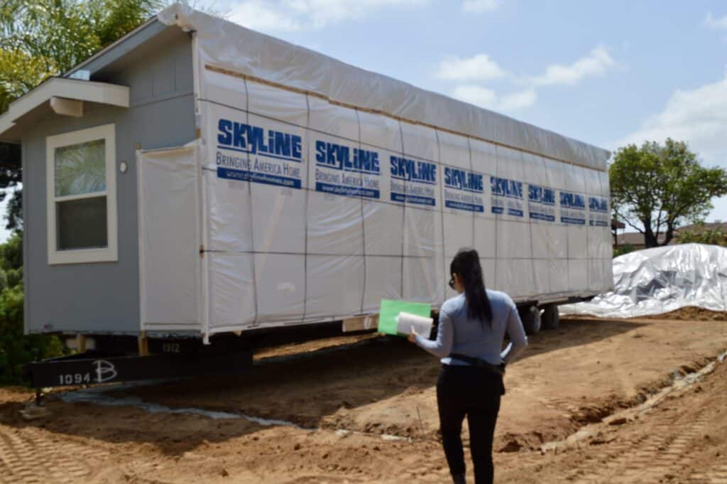 Manufactured home wrapped for transport during delivery