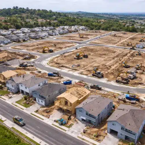 Subdivision Development in Progress Aerial view of an active subdivision showing grading road construction and early home building during land development in San Diego