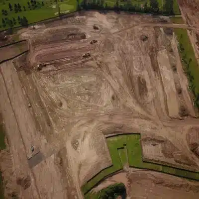 Aerial view of a graded construction site showing earthwork and preparation for future development