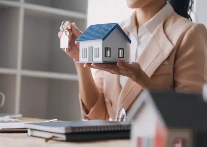 New home keys and model house during purchase process