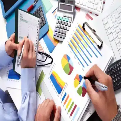 Reviewing charts and cost analysis documents for land development planning and project budgeting